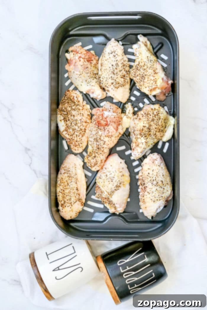 Signature Salt and Pepper Wings 4 Salt and Pepper Wings Air Fryer cooking in a single layer