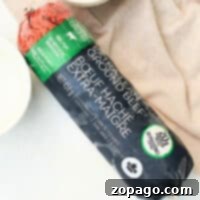 Mastering Frozen Ground Beef 7 A package of frozen extra-lean ground beef sits invitingly on a cloth, framed by tempting cheese in the background. Its a perfect choice for those wondering how to cook frozen ground beef into a delicious meal.