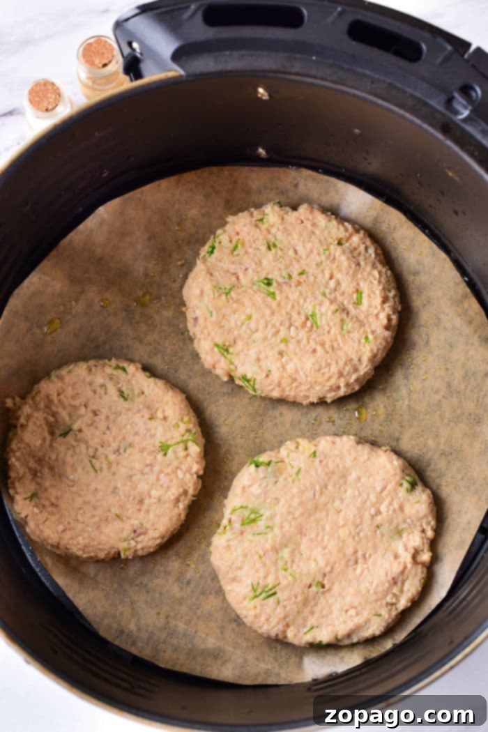 Juicy Air Fryer Turkey Patties 4 Crispy air fryer turkey burgers ready to be served with fresh garnishes.
