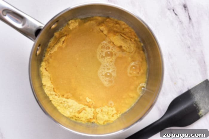 Crafting Your Perfect Hot Dog Mustard 4 Delicious homemade mustard sauce generously applied to hot dogs in buns, ready for a bite.