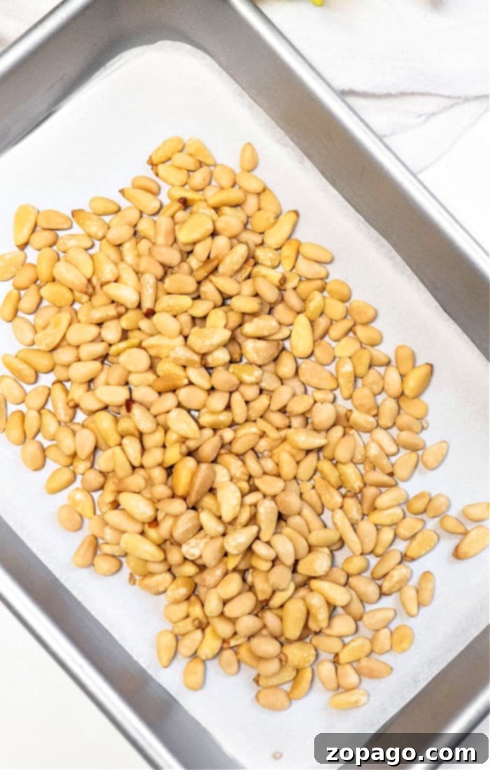 The Secret to Perfectly Roasted Pine Nuts 4 Learn how to roast pine nuts perfectly by starting with them scattered on a parchment-lined baking tray.