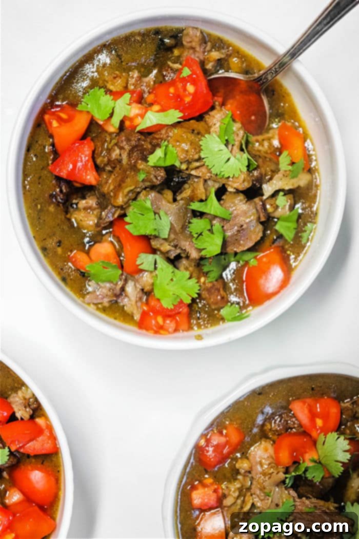 Velvet Oxtail Curry 2 Rich and tender oxtail curry served in a bowl, garnished with fresh herbs.