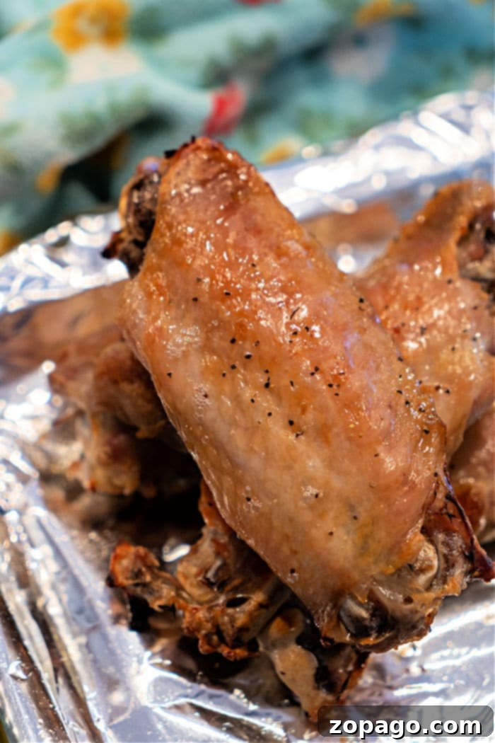 Golden Baked Turkey Wings 6 Crispy Baked Turkey Wings: A bountiful platter of glistening, perfectly crispy baked turkey wings, garnished with fresh herbs, enticingly ready to be enjoyed.