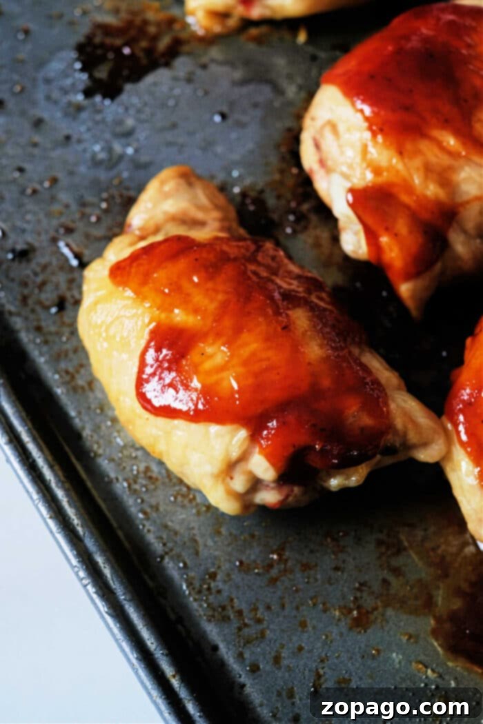 Juicy Oven BBQ Chicken Thighs 4 BBQ Baked Chicken Thighs in Oven - close up of glazed chicken