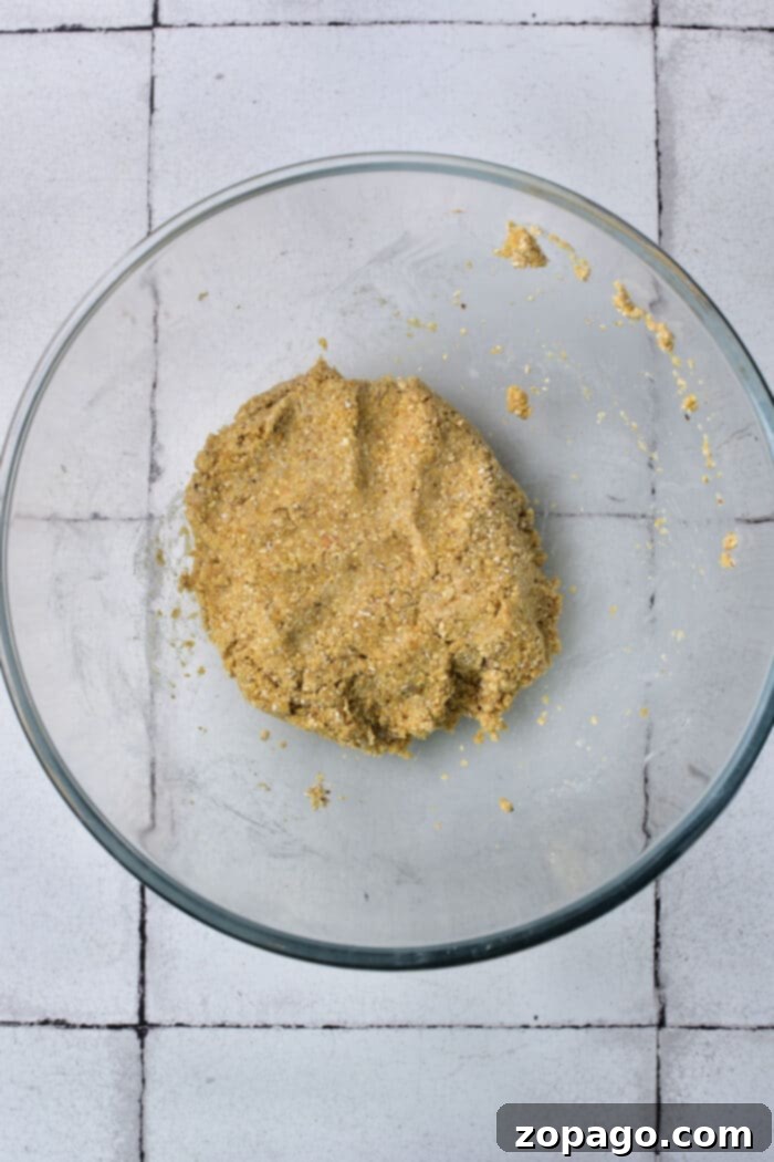 Matzo Ball Explained: Definition and Easy Recipe 5 A close-up of matzo balls simmering in a rich, golden broth, expanding and becoming fluffy