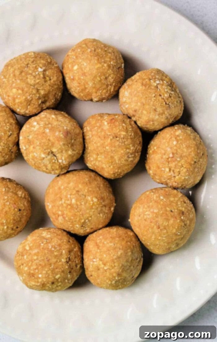 Matzo Ball Explained: Definition and Easy Recipe 8 Twelve round, golden-brown matzo balls, artfully arranged on a white, textured plate.