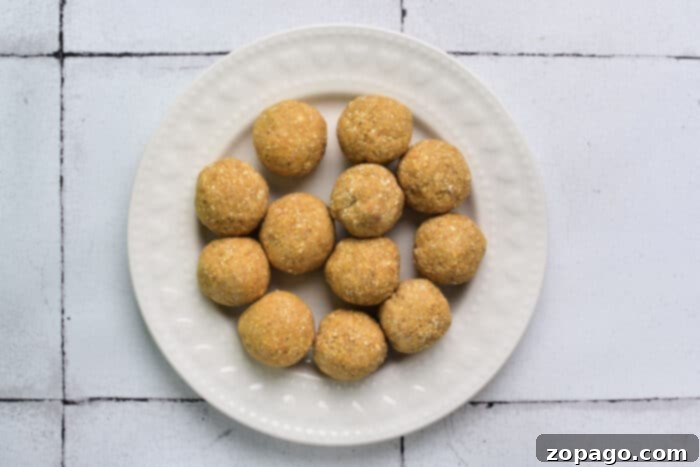 Soul-Warming Chicken Matzo Ball Soup 3 A plate of perfectly round, golden-brown matzo balls, light and fluffy, evoking the warmth of homemade soup.