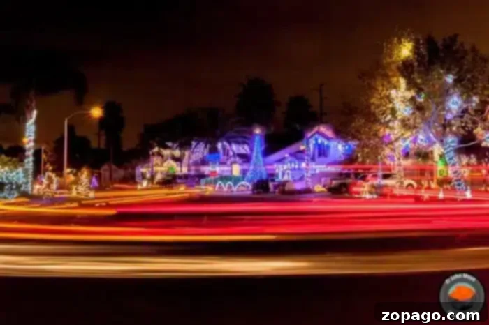 The Ultimate Temecula Christmas Lights Map 2 A festive neighborhood in Temecula at night is illuminated with colorful Christmas lights, displaying various decorations. Light trails from passing vehicles create streaks across the foreground, adding dynamic movement to the scene, like a lively map of holiday cheer.