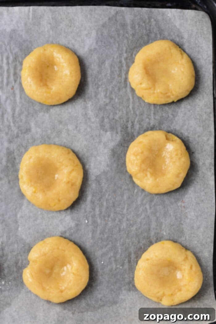 Zesty Lemon Curd Delights 6 A charming stack of lemon curd thumbprint cookies, showing their fluffy texture and the generous amount of lemon curd in each center.