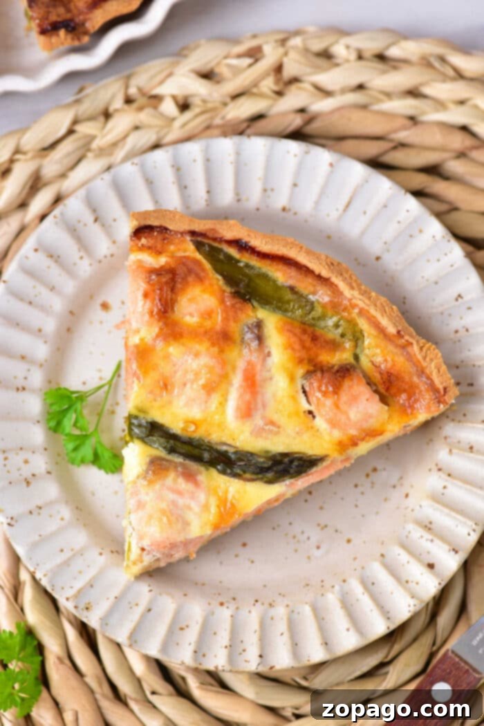 Gourmet Salmon Quiche 7 A perfect slice of homemade salmon quiche, displaying the flaky fish and creamy egg filling.