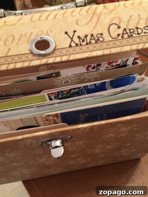 A simple and free tip on what to do with Christmas cards once the season is over, saving them in an accordion file. Accordion file for saving Christmas cards, showing different years of cards.