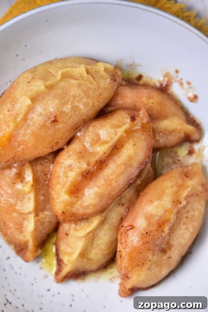 Golden Sweet Potato Pillows 2 Sweet Potato Dumplings, golden brown and glistening with glaze.
