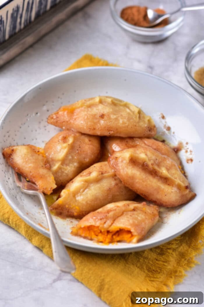 Golden Sweet Potato Pillows 5 Platter of golden brown dessert dumplings with sweet glaze.