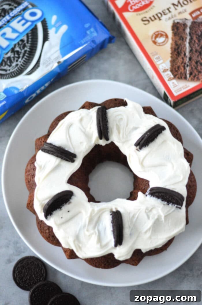 Cookies and Cream Bundt Delight 6 A beautifully frosted Cake Mix Oreo Bundt Cake on a serving platter.
