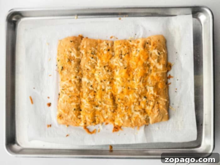 Homemade Little Caesars Cheese Bread 8 Cheesy breadsticks cooling on a rack