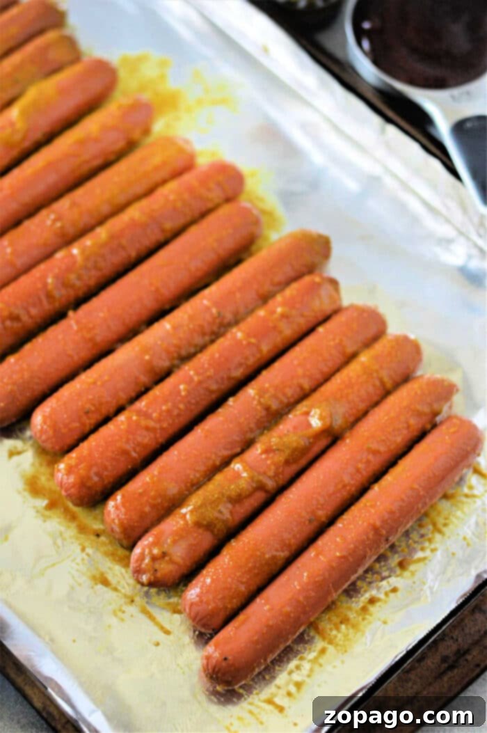Perfect Toaster Oven Hot Dogs 3 Preparing hot dogs for cooking in a toaster oven with slits.