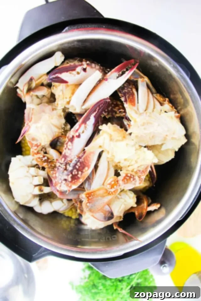 From Freezer to Feast: Perfect Frozen Crab Legs 4 A metal pot filled with raw crab pieces, including claws and legs, sits on a countertop, perfect for learning how to cook frozen crab legs.