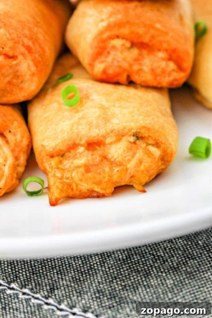 Crispy Buffalo Chicken Rolls 8 A serving platter filled with numerous Buffalo Chicken Rolls, ready to be enjoyed.