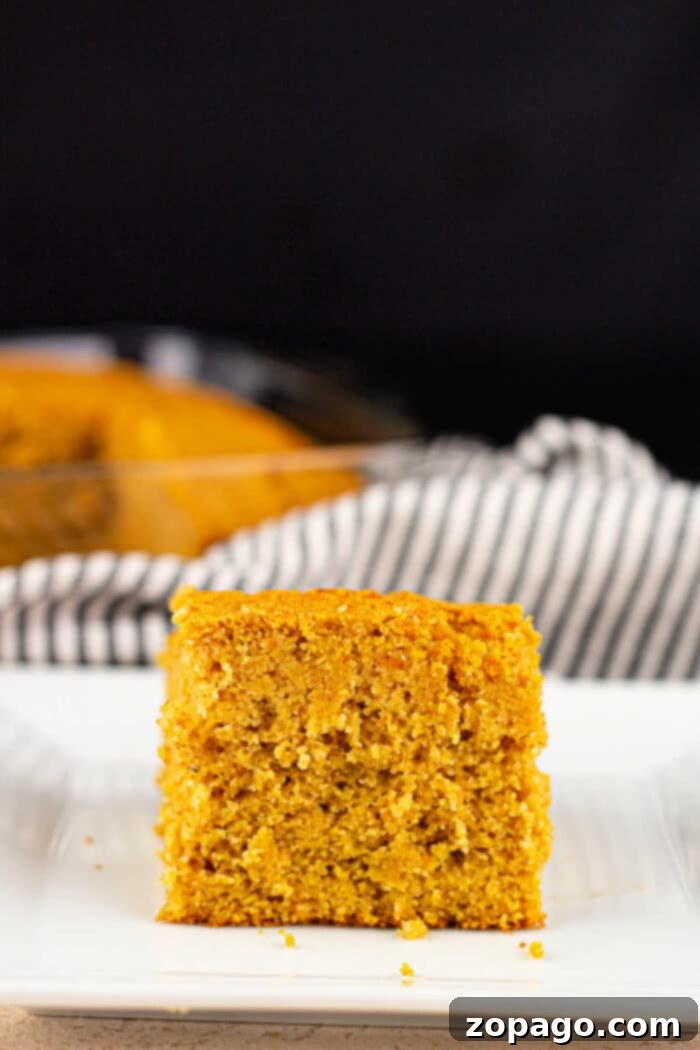 Southern Sweet Potato Cornbread 5 Freshly baked sweet potato cornbread cut into squares, showing its inviting texture.