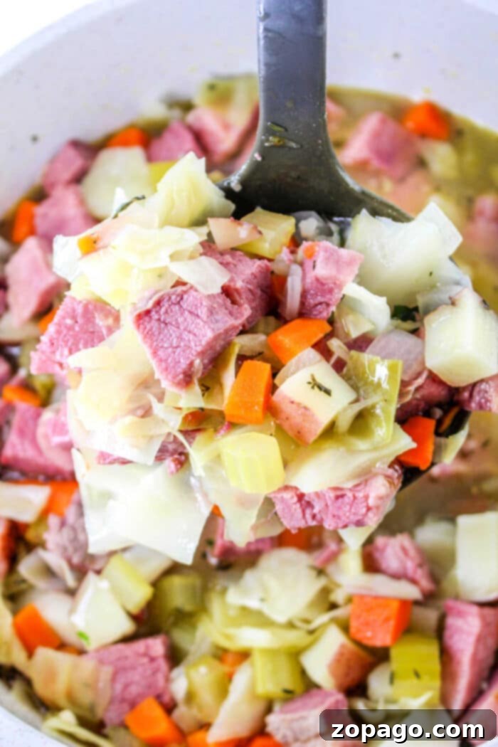 Hearty Corned Beef and Cabbage Bowl 2 Hearty Corned Beef and Cabbage Soup simmering in a Dutch Oven