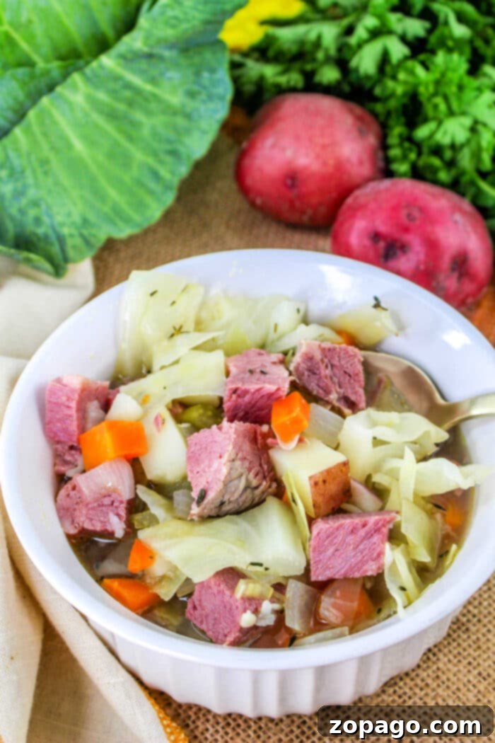 Hearty Corned Beef and Cabbage Bowl 10 A comforting bowl of Leftover Corned Beef and Cabbage Soup garnished with fresh herbs