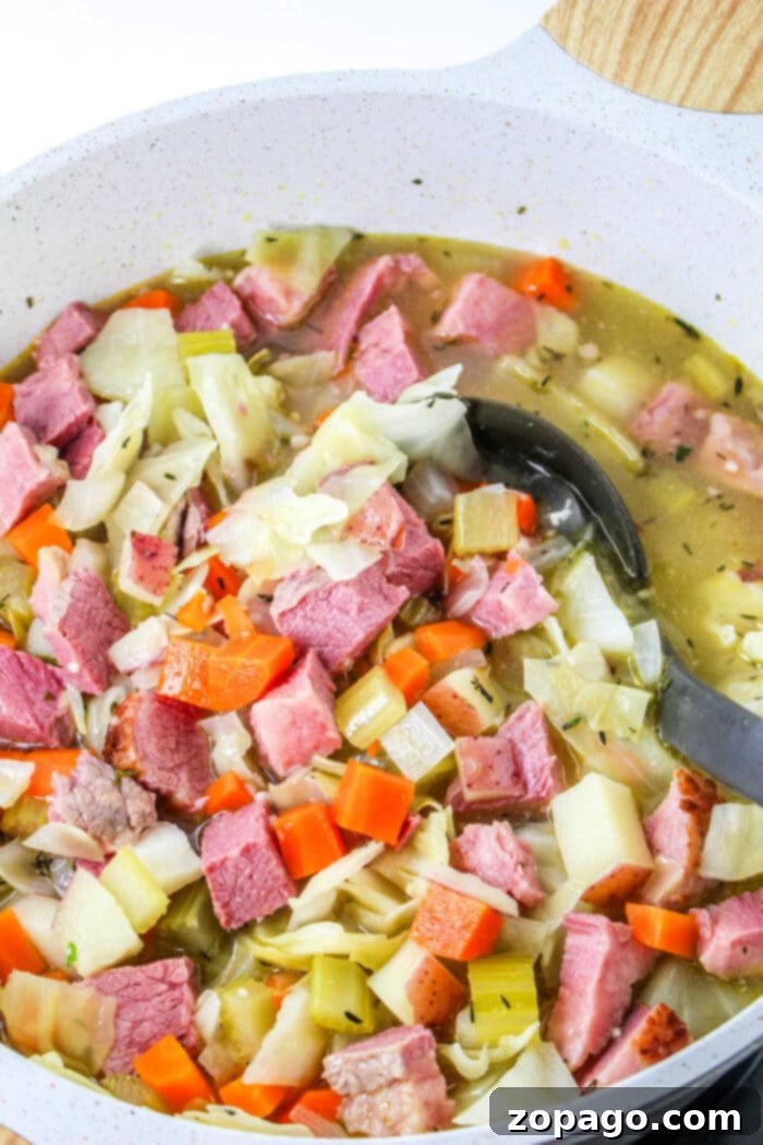 Hearty Corned Beef and Cabbage Bowl 6 A close-up of a pot of hearty Corned Beef and Cabbage Soup