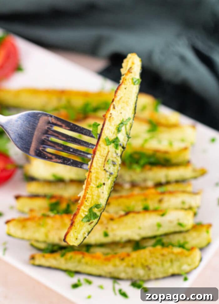 Roast Zucchini Perfectly Every Time 2 Crispy Roasted Zucchini Spears on a Baking Sheet