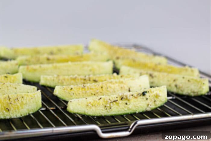Roast Zucchini Perfectly Every Time 4 Close-up of crispy baked zucchini spears on a baking sheet