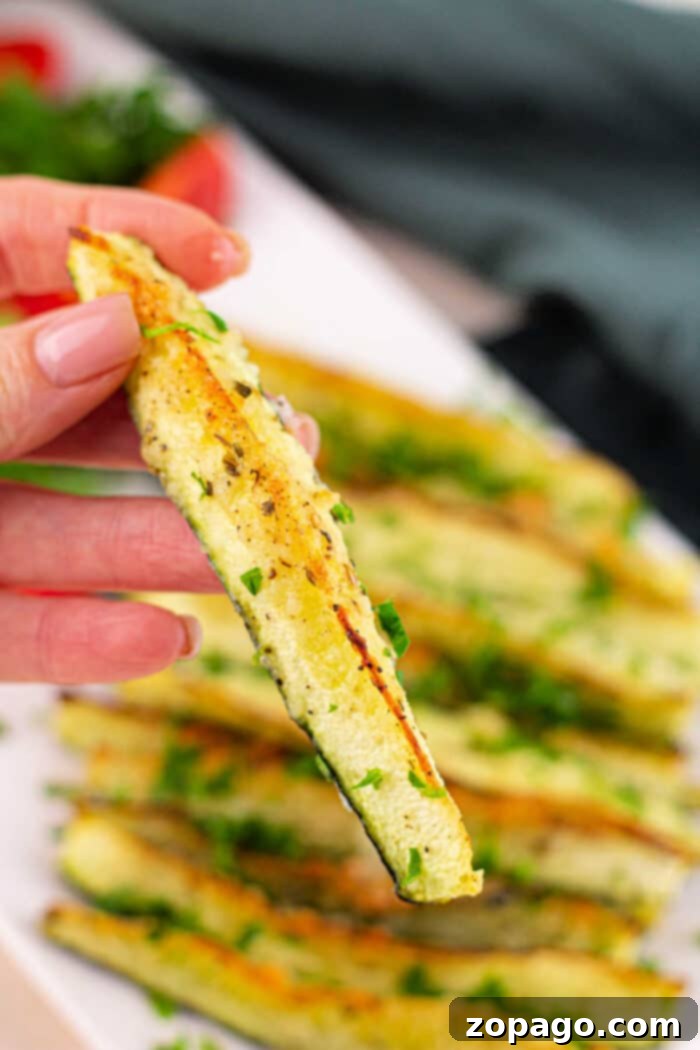 Roast Zucchini Perfectly Every Time 7 Close-up of perfectly roasted zucchini pieces, glistening with olive oil and seasonings