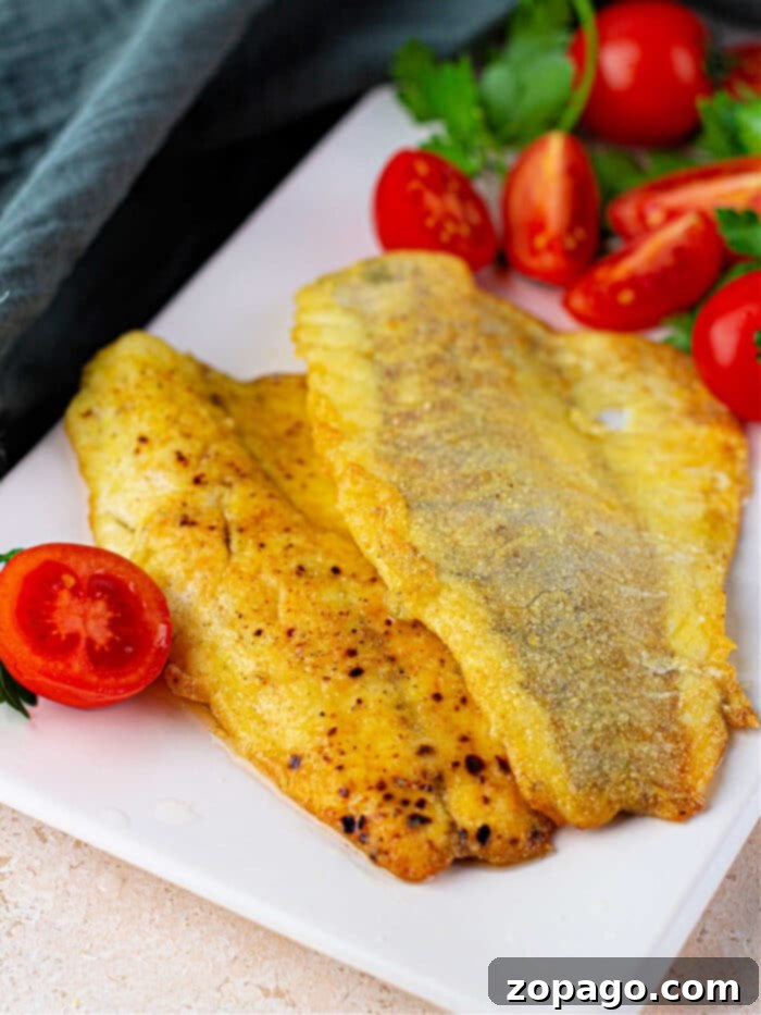 Golden Pan Fried Swai 2 Frying Swai Fish fillets to golden perfection in a hot pan.
