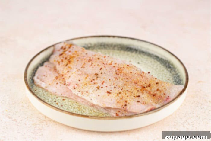 Golden Pan Fried Swai 3 Two Swai fish fillets, ready to be cooked, displayed on a clean surface.
