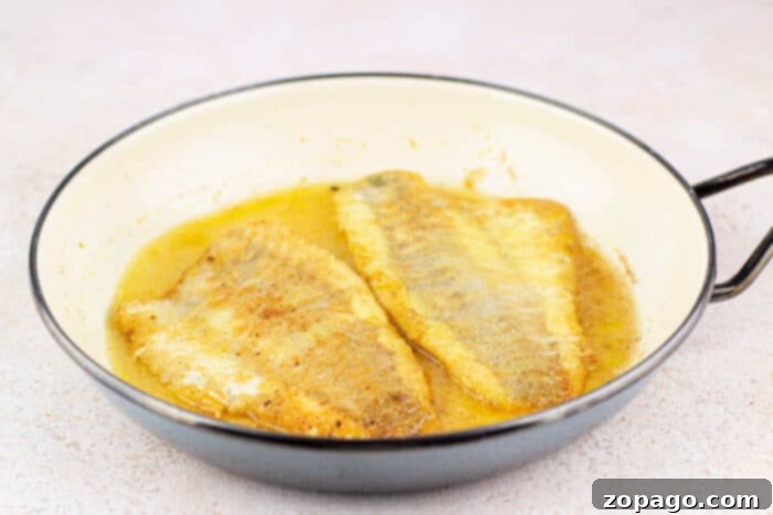 Golden Pan Fried Swai 5 Crispy Fried Swai Fish served on a platter, garnished with fresh herbs.