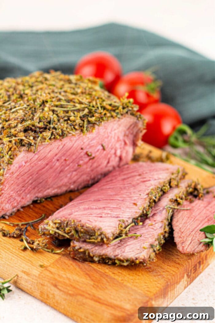 Tender Bottom Round Roast Made Easy 2 A beautifully cooked bottom round roast, sliced and ready to serve, showing a perfect pink interior.