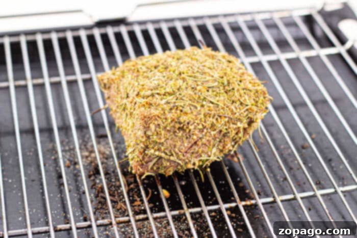 Tender Bottom Round Roast Made Easy 5 Close-up showing a meat thermometer inserted into a Bottom Round Roast during the cooking process.