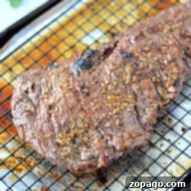 Perfect Oven Skirt Steak Recipe 8 A perfectly broiled skirt steak resting on a wire rack with a savory seasoning on top basks in the warmth of the oven.