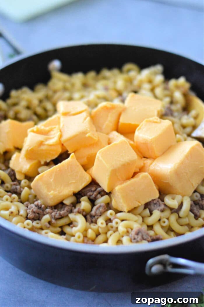 Creamy Cheesy Beef and Pasta Skillet 4 Velveeta Cheeseburger Helper: A top-down view of a skillet full of rich, cheesy pasta and ground beef, ready to be served.