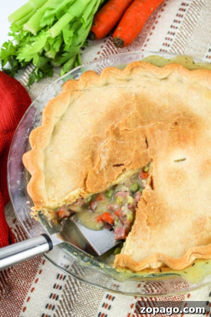 Hearty Ham Pot Pie 7 Leftover Ham Pot Pie, showing a hearty slice ready to be eaten