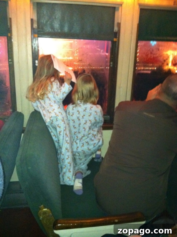 Best vacation spots for kids! Here is where you should take them while they''re still young, our top 10 favorite vacations with kids. #vacation #withkids #travel #familytravel A family excitedly aboard The Polar Express train, dressed in pajamas for a magical Christmas journey.