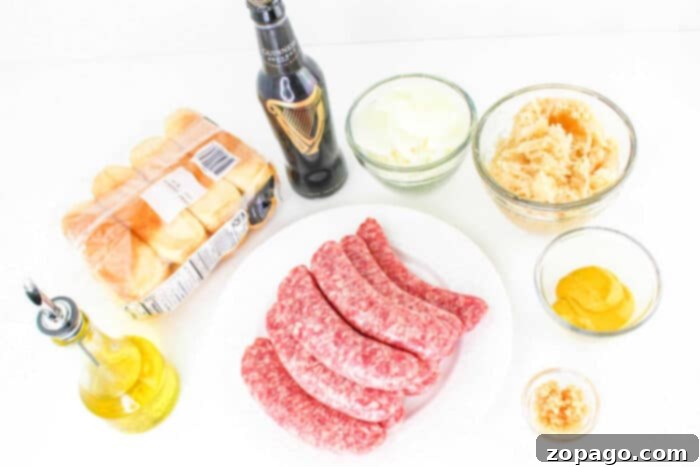 Perfectly Cooked Bratwurst Every Time 3 A variety of ingredients are laid out on a white surface for how to cook bratwurst. Included are six raw sausages on a white plate, a bottle of Guinness beer, a pack of Hawaiian rolls, a bottle of olive oil, and bowls containing sliced onions, sauerkraut, mustard, and minced garlic.