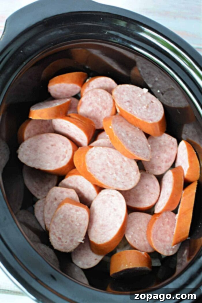 Set It and Forget It Kielbasa 5 Kielbasa in Crock Pot with beer and sweet onions, a savory combination