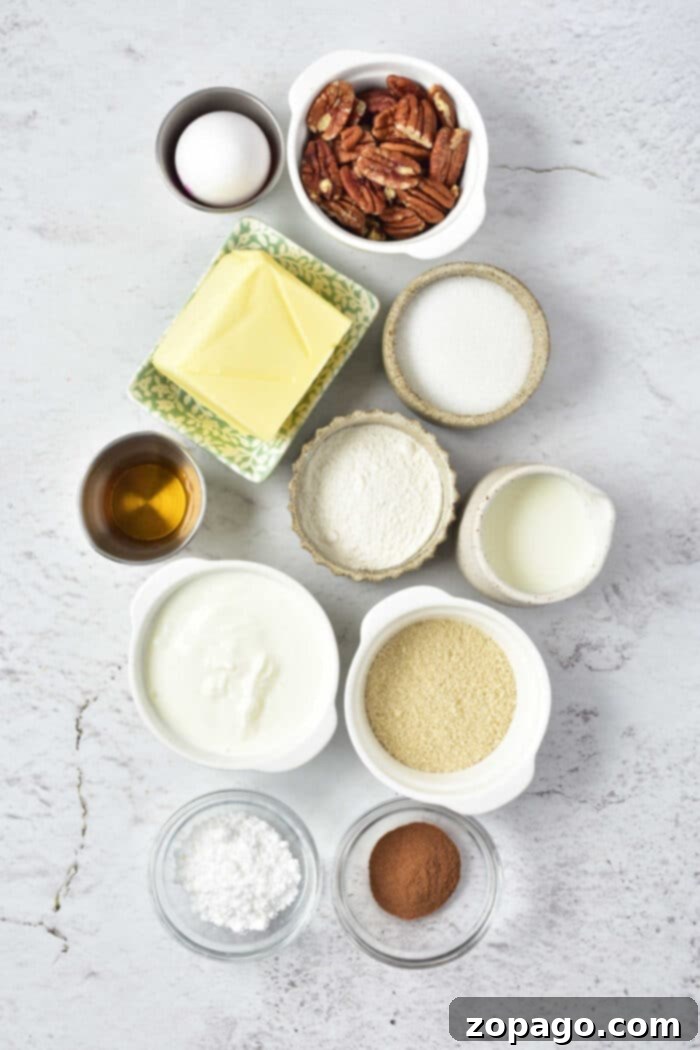 Ultimate Sock It To Me Cake with Cake Mix 3 A flat lay of all the essential ingredients for an easy Sock It to Me cake recipe: yellow cake mix, eggs, butter, sour cream, granulated sugar, vanilla extract, brown sugar, cinnamon, pecans, powdered sugar, and milk.