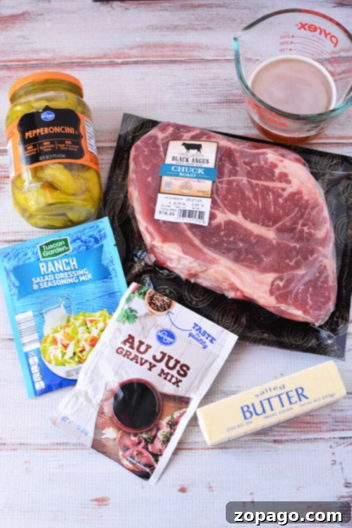 Slow Cooker Mississippi Pot Roast 3 Ingredients for a Mississippi Pot Roast recipe: beef chuck roast, pepperoncini jar, au jus mix, ranch mix, butter stick, and beef broth.
