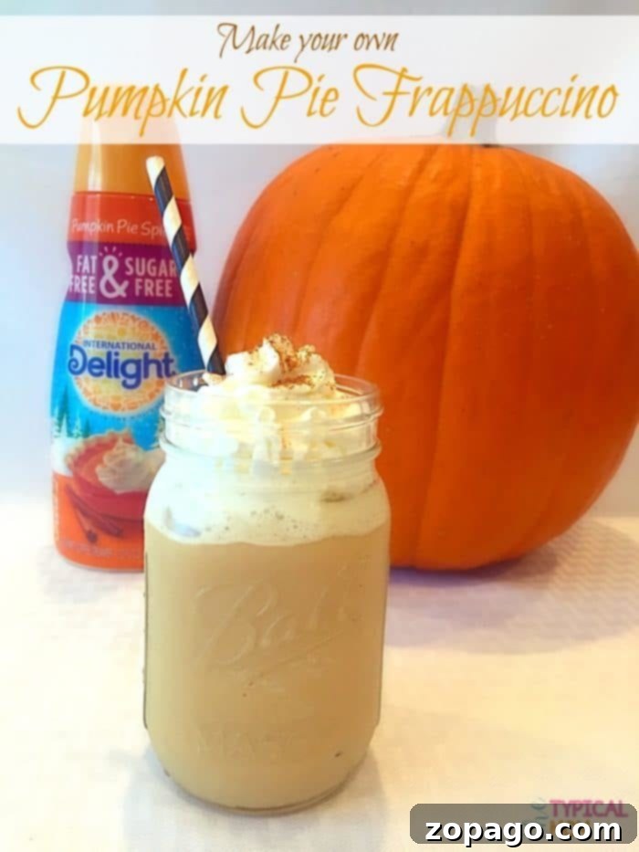 EASY pumpkin spice frappuccino recipe you can make at home with just a few ingredients. SO delicious, will never buy one of these again! A vibrant pumpkin spice frappuccino with a garnish of cinnamon stick and star anise, sitting on a wooden table