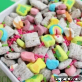 A colorful cereal mix with marshmallows and sprinkles in a white bowl, reminiscent of a playful take on a Peanut Butter Muddy Buddies recipe.