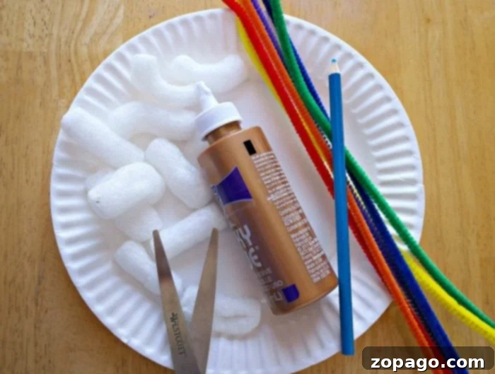 Kaleidoscope Weaving 2 A collection of craft supplies including a bottle of brown craft glue, a pencil, colorful pipe cleaners, scissors, and white packing peanuts, all arranged on a wooden surface for a rainbow weaving art project.