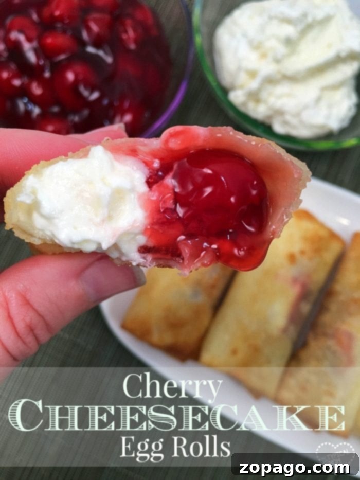 Cherry cheesecake egg rolls are amazing!! Just 3 ingredients in this warm dessert egg roll recipe. SO easy and the easiest cheesecake recipe ever. #cherrycheesecake #cheesecake #eggrolls #desserteggrolls #cherry #thetypicalmom A hand holds a cherry cheesecake egg roll, its filling tantalizingly visible. In the background, a plate overflows with more delectable cherry cheesecake egg rolls alongside bowls brimming with cherries and cream.