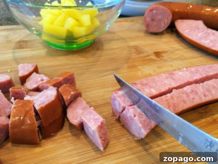 Cooking sausage for a flavorful lettuce wrap filling. Hillshire Farm sausage slices browning in a skillet for lettuce wraps.