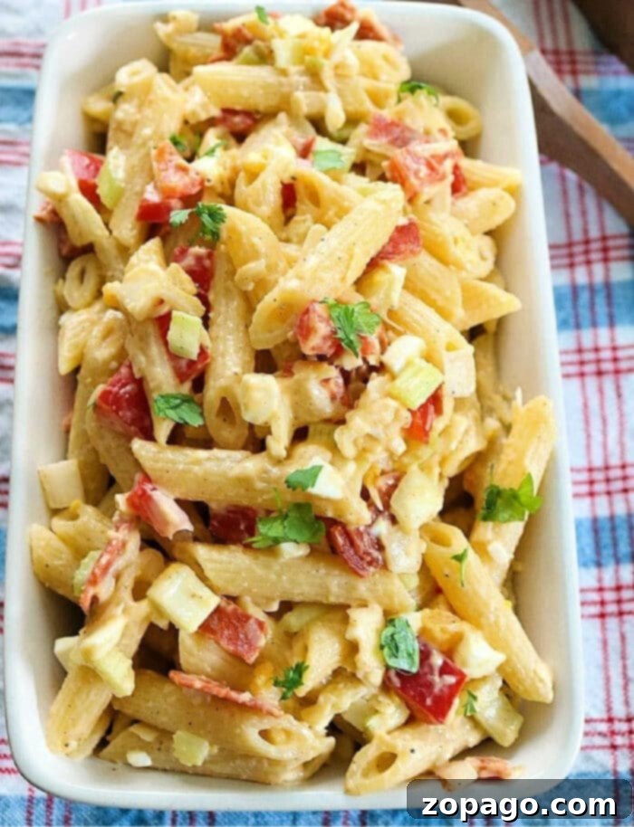 Dreamy Creamy Pasta Salad 2 Creamy Pasta Salad with Mayo, garnished with fresh herbs in a serving bowl.