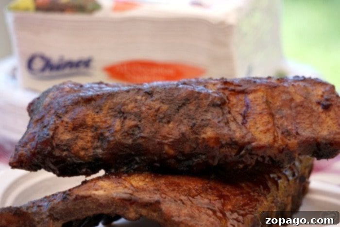 Serve up the best barbecue ribs recipe, perfect for any gathering. A vibrant platter of smoked barbecue ribs, garnished and ready for a feast.