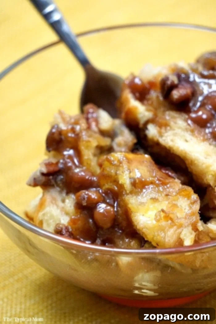 Caramel pecan Crockpot French toast casserole is insane!! It's SO easy to make and a perfect brunch or Christmas breakfast!! Slow cooker style! Delicious caramel pecan Crockpot French toast casserole, adorned with a light dusting of powdered sugar, perfect for a cozy breakfast or holiday brunch.